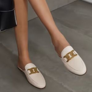 White Tod’s leather mules with chain details.